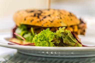 Sandwich hamburger with and mix of vegetables. Fast food. Delicious hamburger