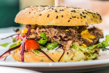 Sandwich hamburger with and mix of vegetables. Fast food. Delicious hamburger