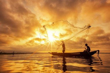 Fishermen casting net for catching fish clipart