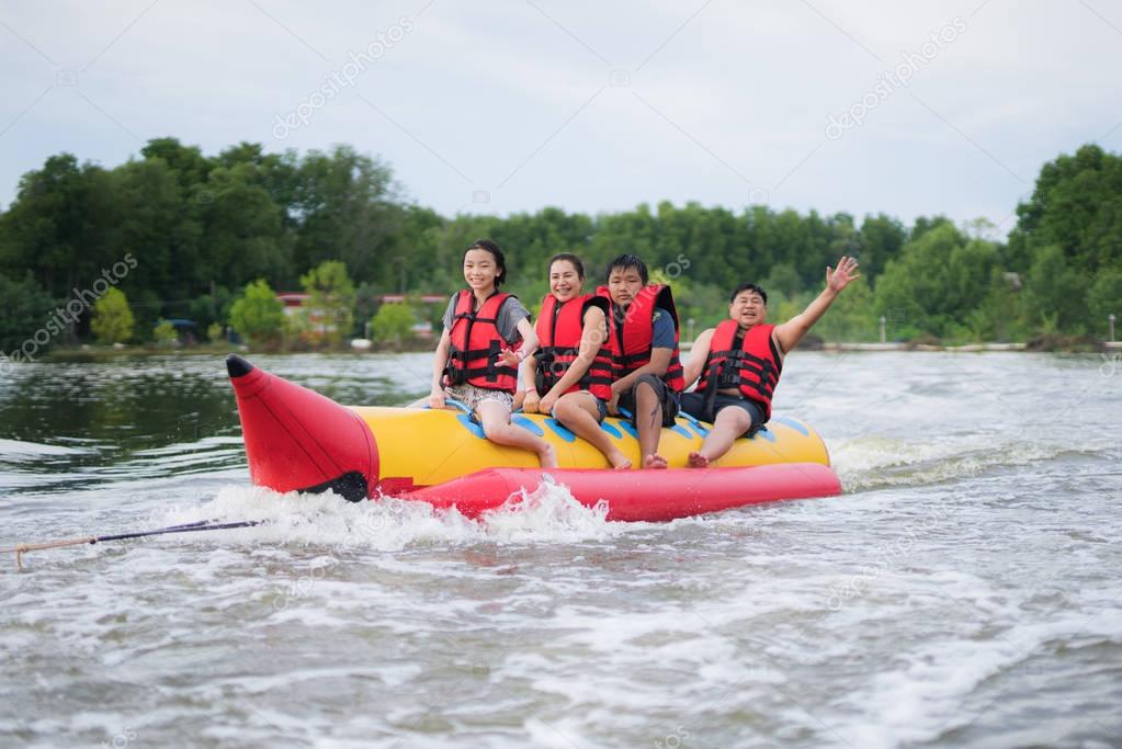 Asian family play banana boat