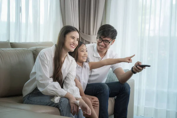 Asian family see the movie togather on sofa in living room — Stock Photo, Image