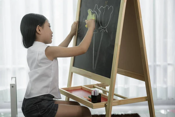 Asijské školka student čerpat a malovat barvu na blackbord i — Stock fotografie