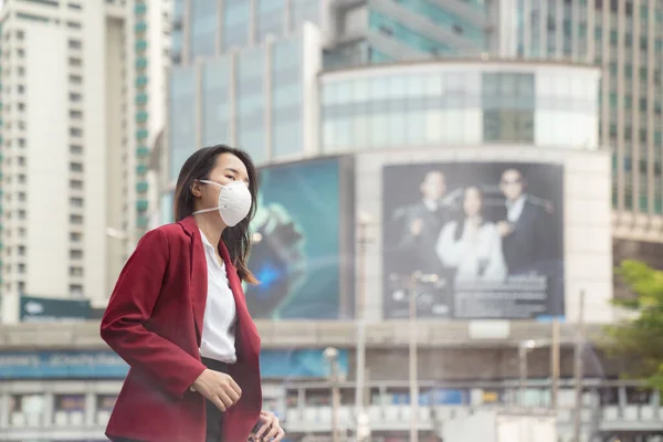 Asian girl use a protection mask for prevent PM 2.5 and corona viruus or covic 19 in Bangkok city.
