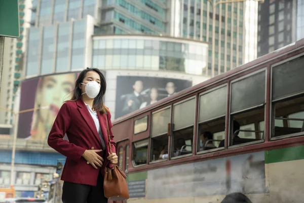 Asian girl use a protection mask for prevent PM 2.5 and corona viruus or covic 19 in park of Bangkok city
