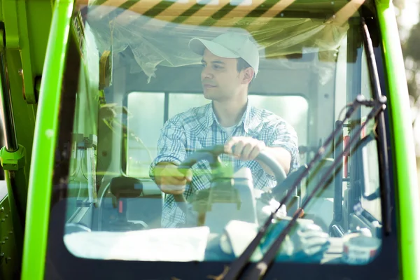 Young farmer in combine — Stock Photo, Image