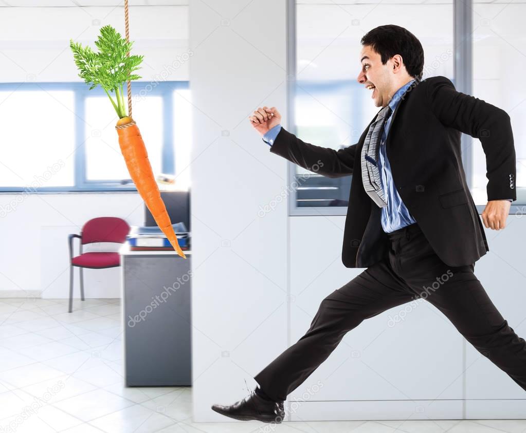 Businessman trying to take a carrot