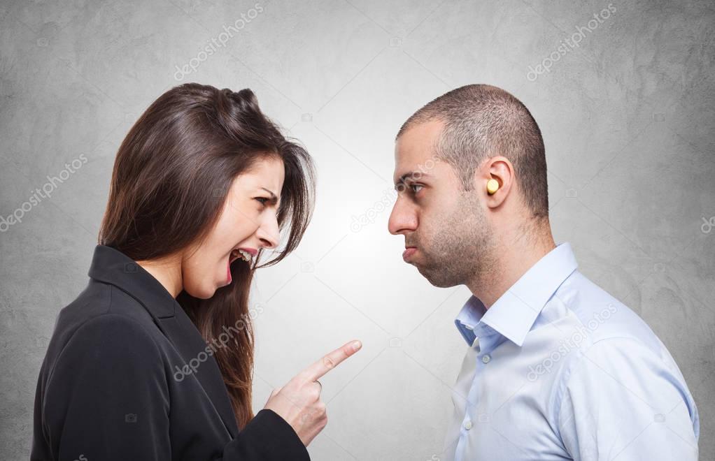 Man in front of an angry woman