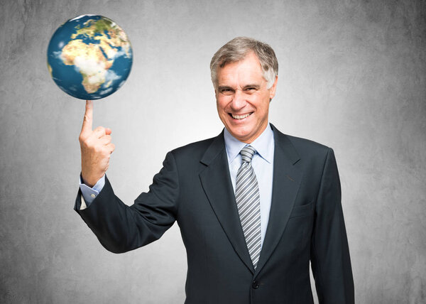 Businessman spinning a globe on finger