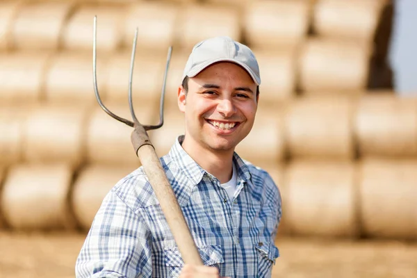 Farmer holding pitchfork — Stock Photo, Image