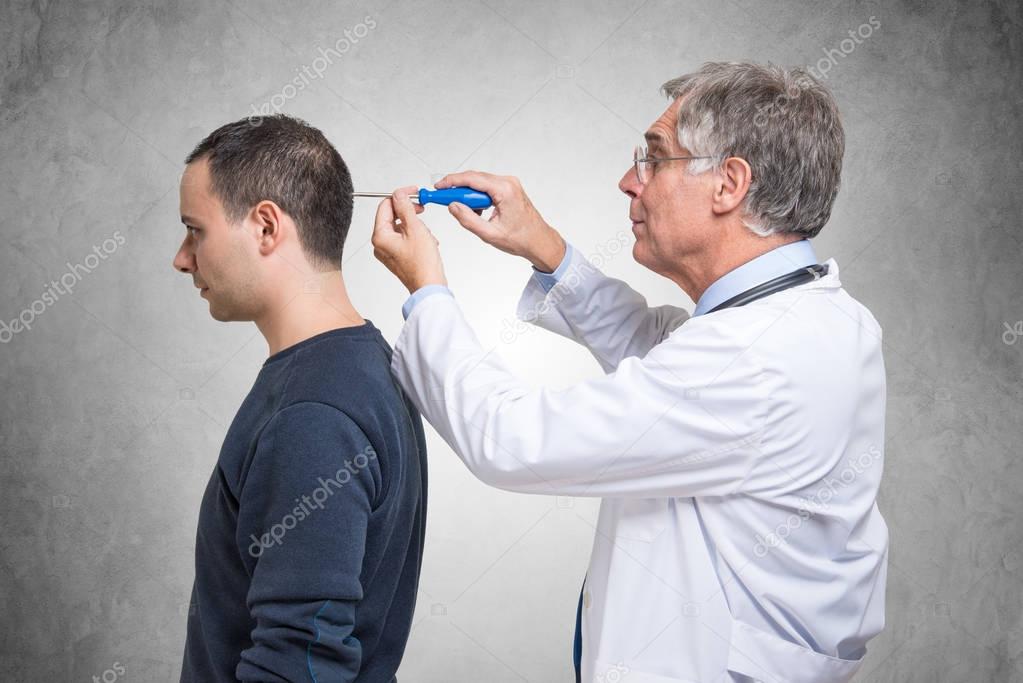 Psychiatrist using a screwdriver to fix patient mind