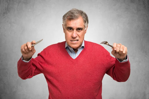 Hungry man holding fork and knife — Stock Photo, Image