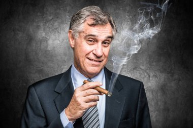 senior businessman smoking a cigar clipart