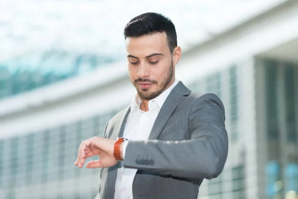 Businessman looking at wrist watch — Stock Photo, Image