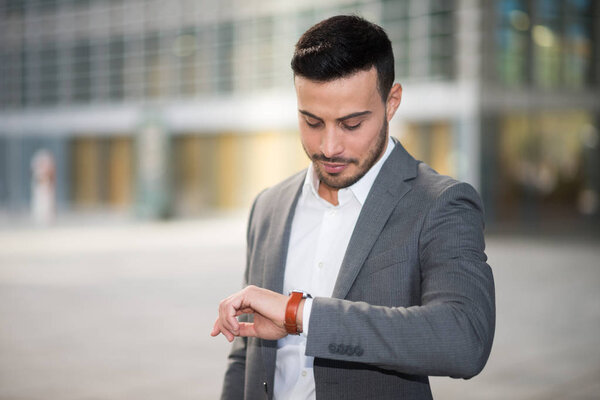 man looking at his wrist watch