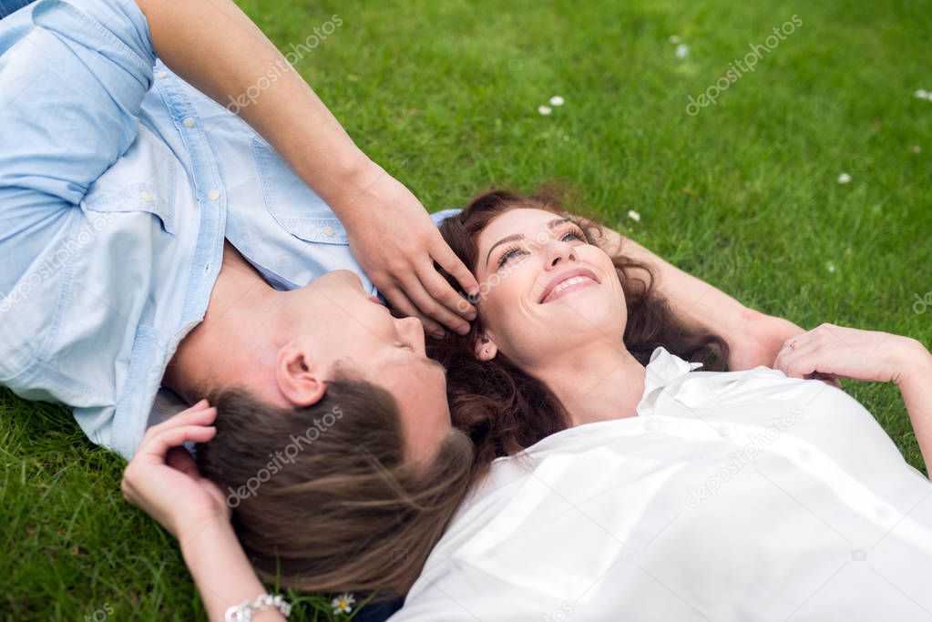 couple relaxing on grass