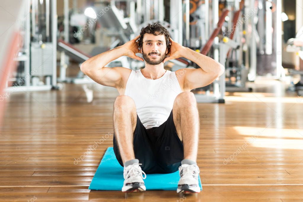 Man working out abdomen in gym