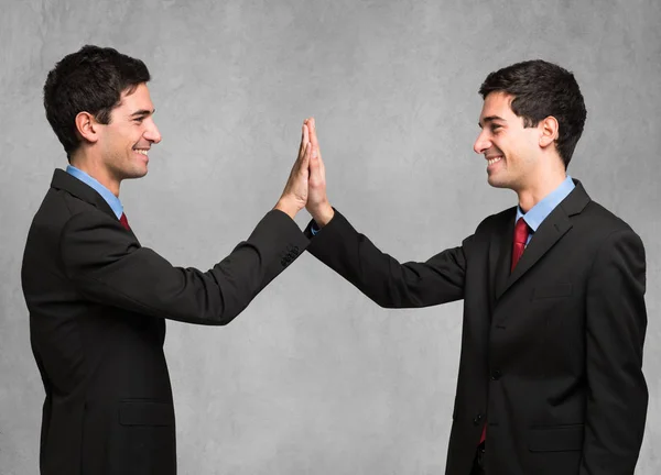 Smiling man high fiving to himself — Stock Photo, Image