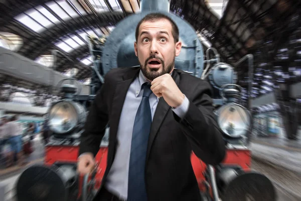 Businessman escaping from vintage train — Stock Photo, Image
