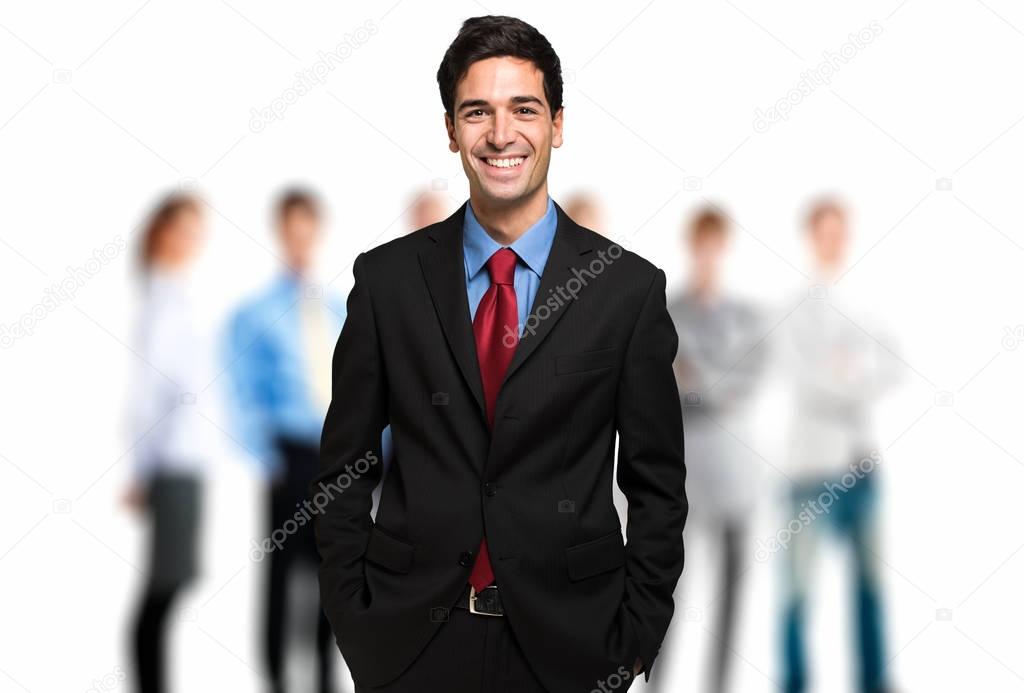Young businessman in front of team