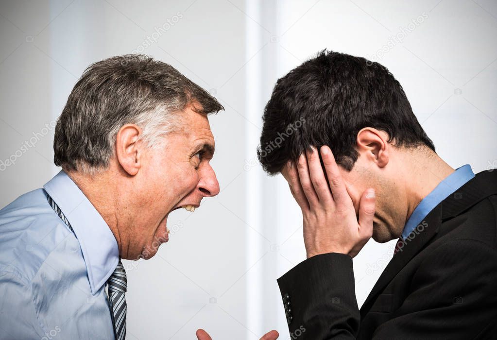 Angry boss shouting to an employee