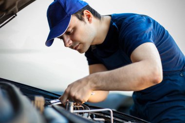 Mechanic fixing car engine clipart