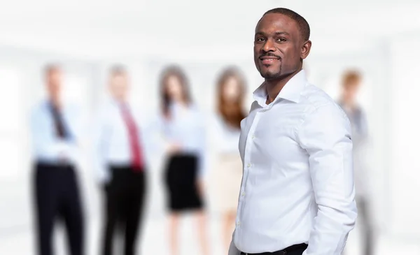 African businessman in front of his team — Stock Photo, Image