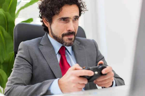 Laze businessman playing video games — Stock Photo, Image