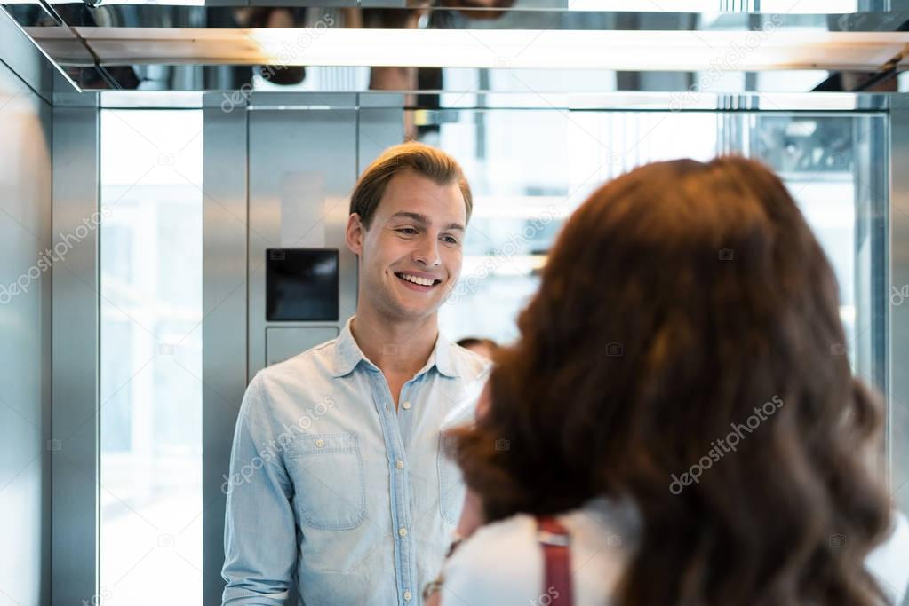 People in an elevator talking
