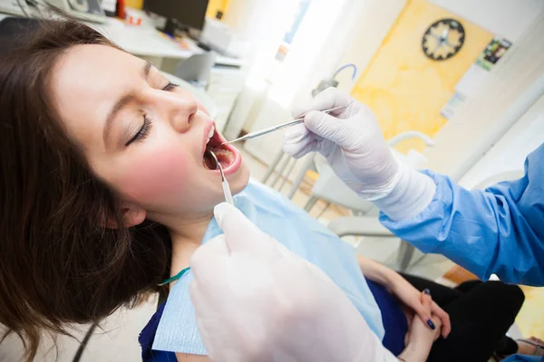 Dentist at work with female patient — Stock Photo, Image