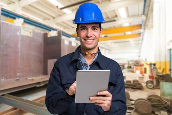 Smiling engineer using a tablet