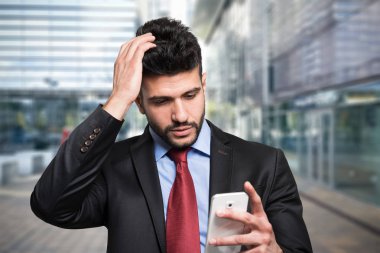 worried man looking at phone clipart