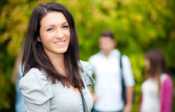 Female student in front of another students — Stock Photo, Image