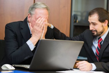 Businessman comforting his depressed and sad boss clipart