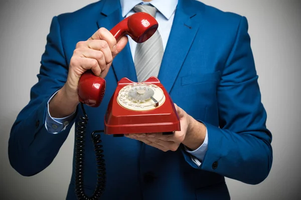 Man in suit holding old vintage phone — Stock Photo, Image