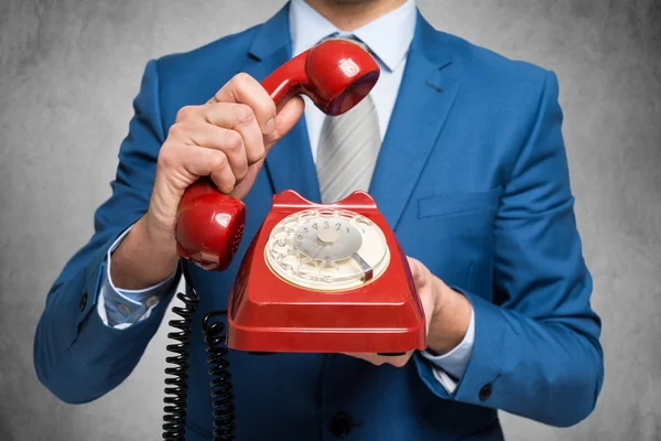 Businessman holding a vintage phone — Stock Photo, Image