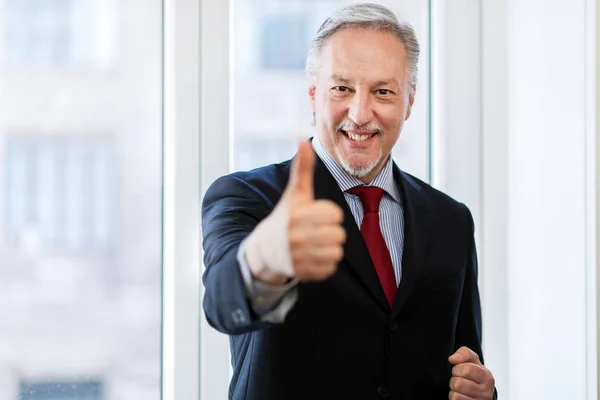 Reifer Geschäftsmann zeigt Daumen hoch — Stockfoto