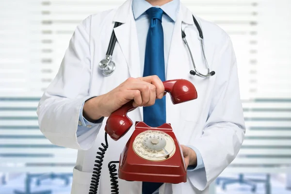 Doctor holding a vintage phone — Stock Photo, Image