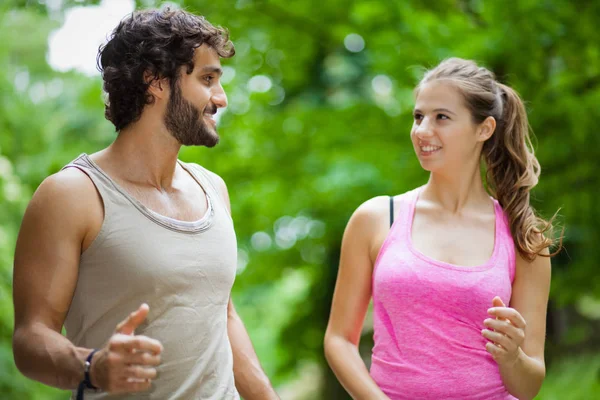 Couple running in a park — Stock Photo, Image