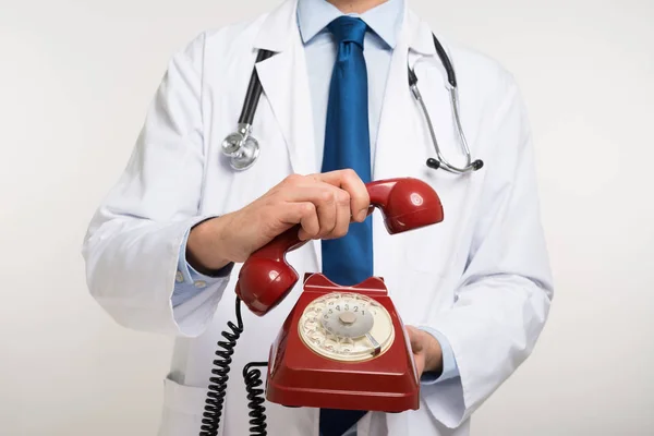 Doctor holding a vintage phone