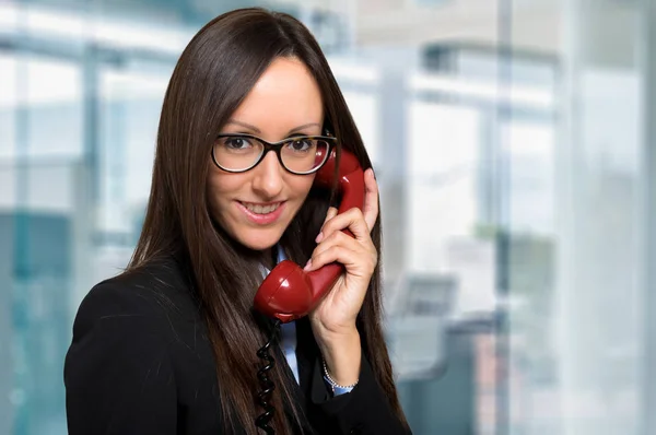 Obchodnice s červeným retro telefon — Stock fotografie