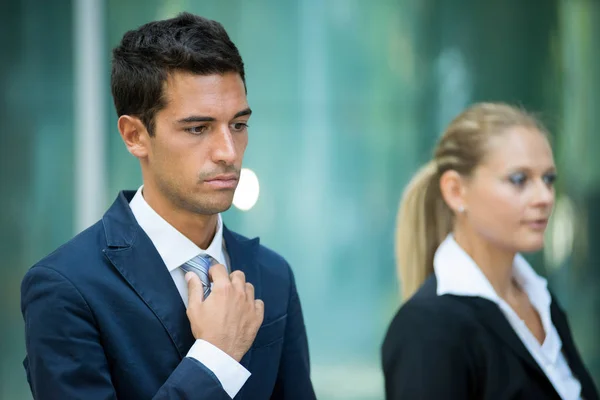 businessman adjusting his necktie