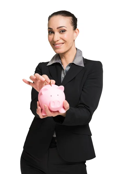 Mulher colocando dinheiro em seu banco porquinho — Fotografia de Stock