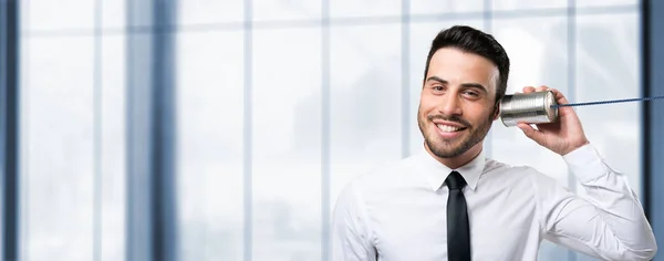 Man talking on a thin can — Stock Photo, Image