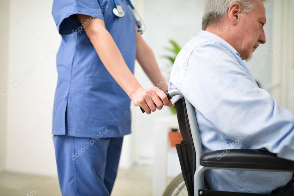 Nurse pushing patients wheelchair
