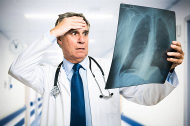 doctor looking at a lung radiography clipart