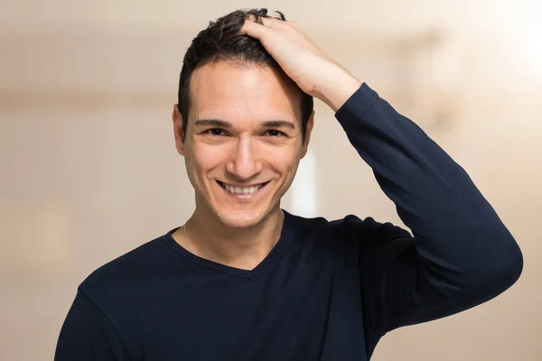 Smiling man touching his hair — Stock Photo, Image