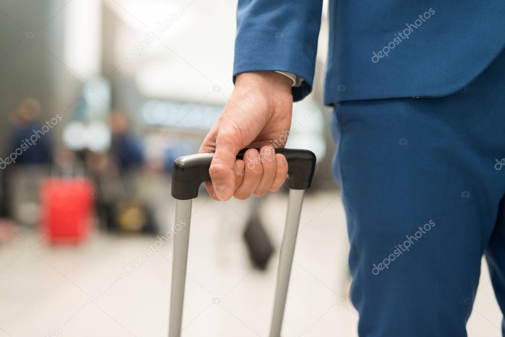 Detail of a traveler pushing his trolley