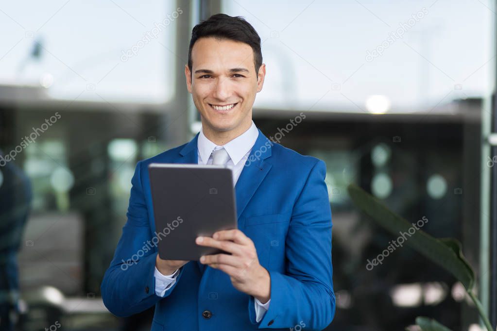 handsome businessman using tablet 