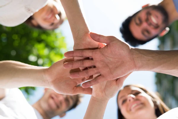 Friends putting their hands together — Stock Photo, Image