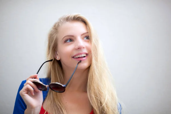 Woman holding sunglasses — Stock Photo, Image